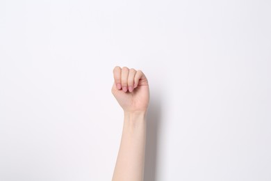 Photo of SOS gesture. Woman showing signal for help on white background, closeup