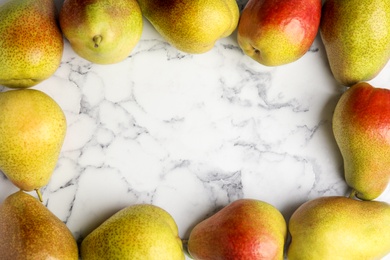 Photo of Ripe juicy pears on marble table, flat lay. Space for text