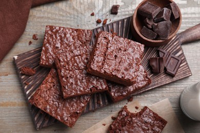 Photo of Delicious chocolate brownies on wooden table, flat lay