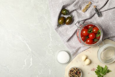 Pickling jar with fresh ripe cherry tomatoes and spices on grey table, flat lay. Space for text