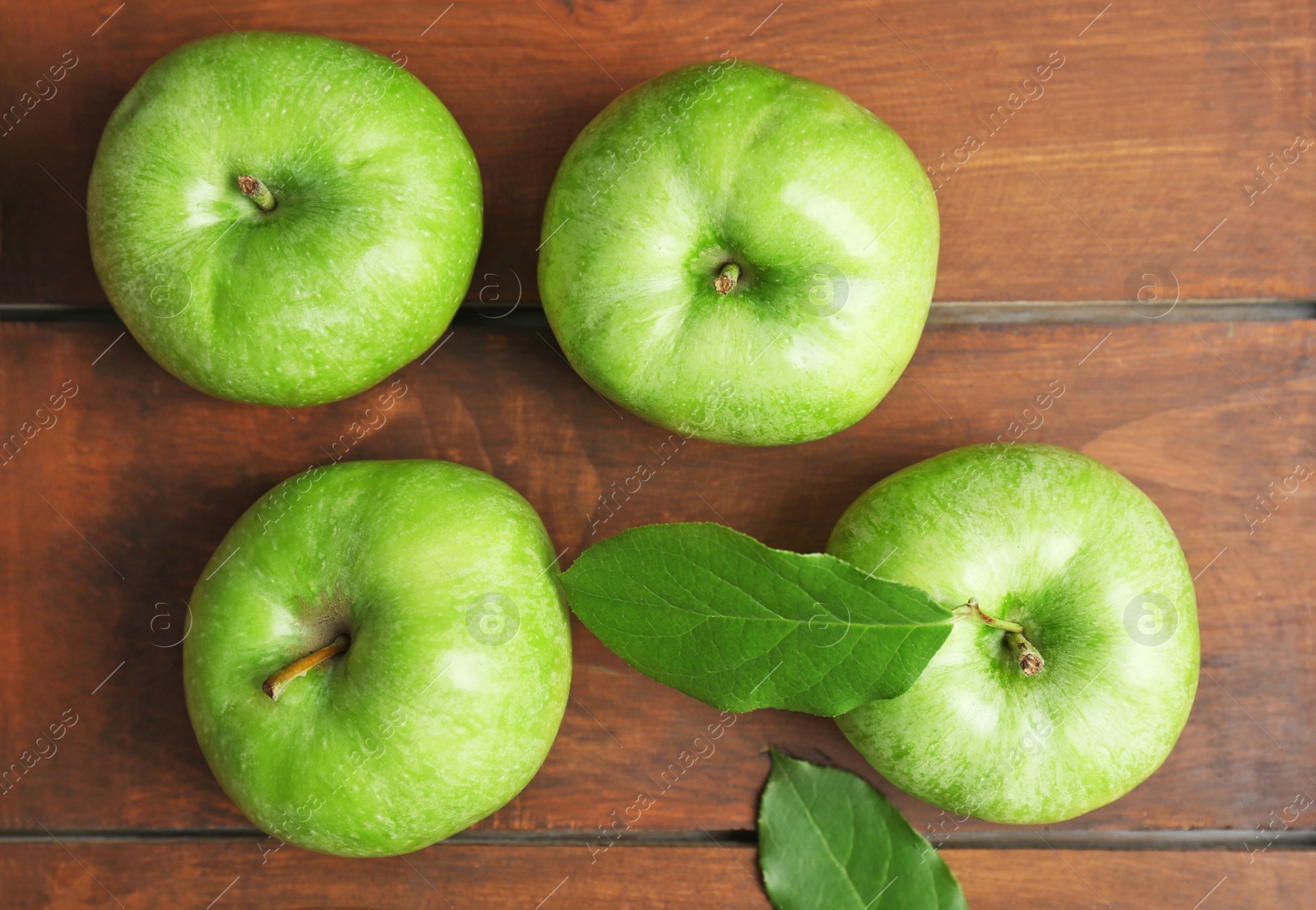 Photo of Fresh green apples on wooden background, top view