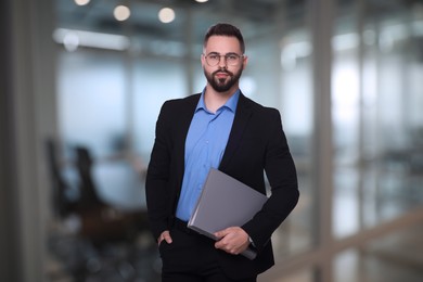 Image of Successful lawyer with laptop on blurred background