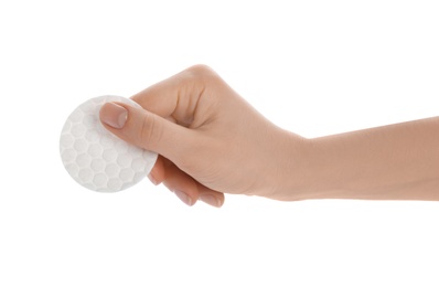 Woman holding cotton pad on white background, closeup