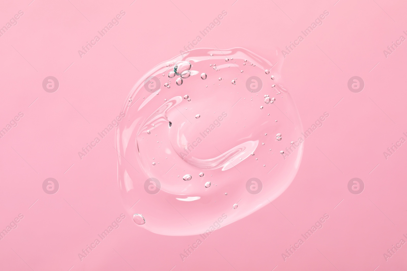 Photo of Sample of cleansing gel on light pink background, top view. Cosmetic product