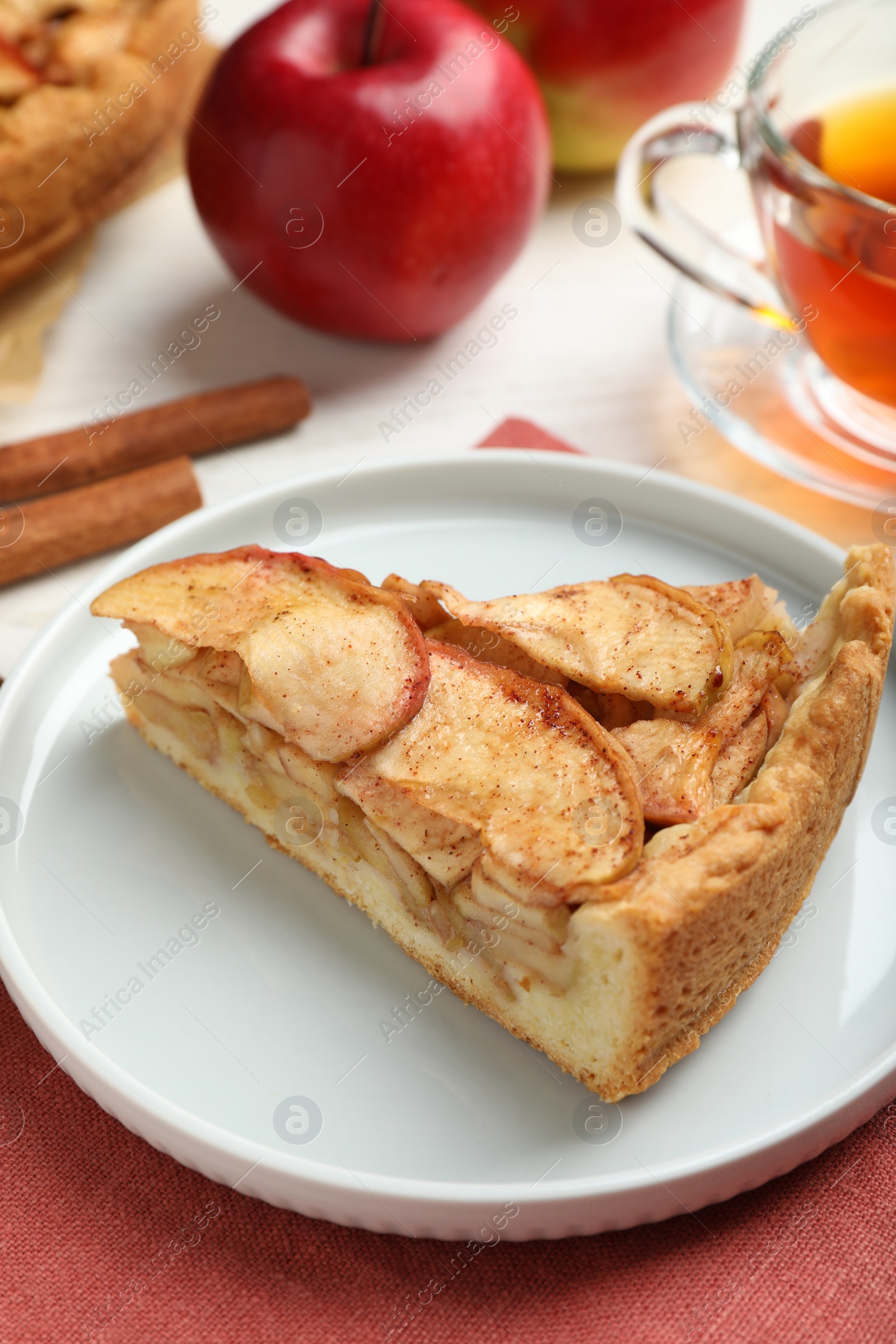 Photo of Slice of delicious apple pie served on table, closeup