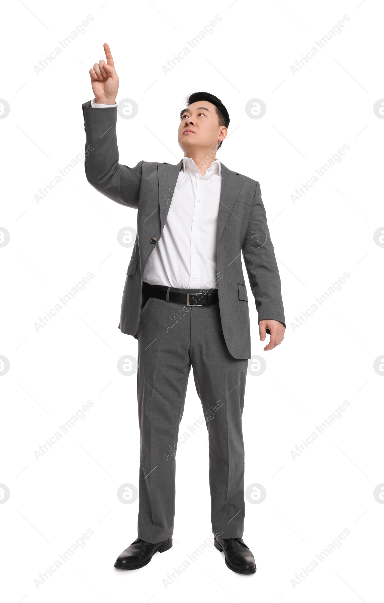 Photo of Businessman in suit posing on white background, low angle view