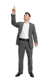 Businessman in suit posing on white background, low angle view