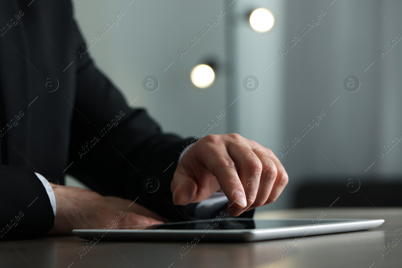 Photo of Closeup view of man using new tablet at desk indoors