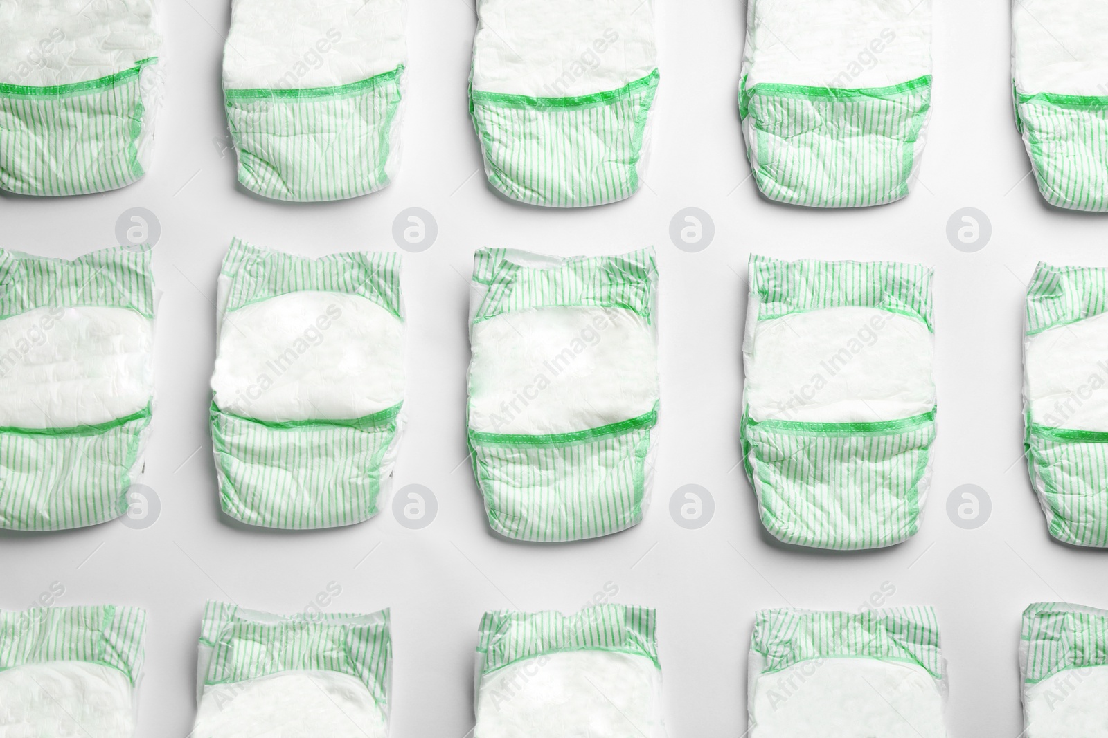 Photo of Flat lay composition with diapers on white background. Baby accessories
