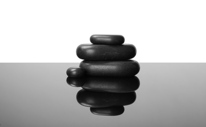 Photo of Stack of spa stones on mirror surface