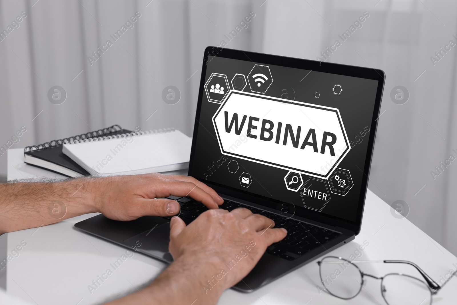 Image of Webinar. Man using laptop at table, closeup