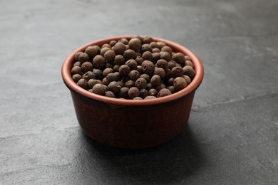 Photo of Dry allspice berries (Jamaica pepper) on black table