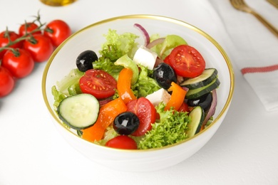 Photo of Tasty fresh Greek salad on white table, closeup