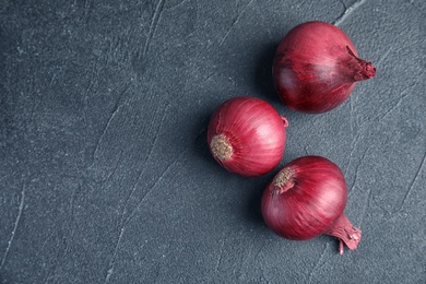 Photo of Ripe red onions on table, top view