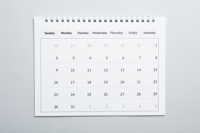 Photo of Paper calendar on light grey background, top view