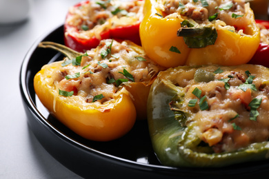 Photo of Tasty stuffed bell peppers on grey table, closeup