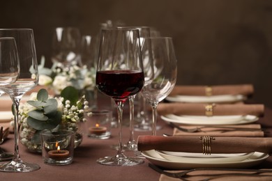 Photo of Glass of delicious wine and elegant table setting in restaurant