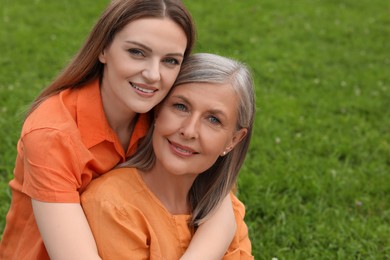 Happy mature mother and her daughter outdoors