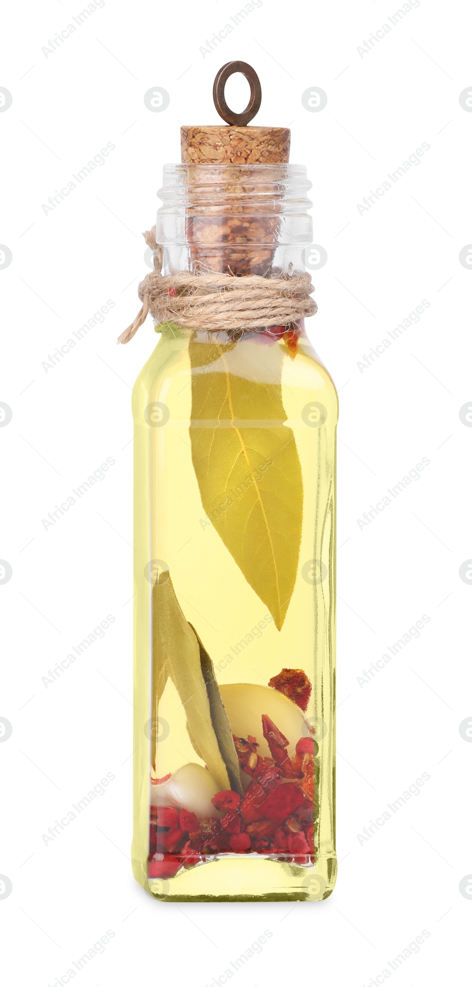 Photo of Glass bottle of cooking oil with spices and herbs isolated on white