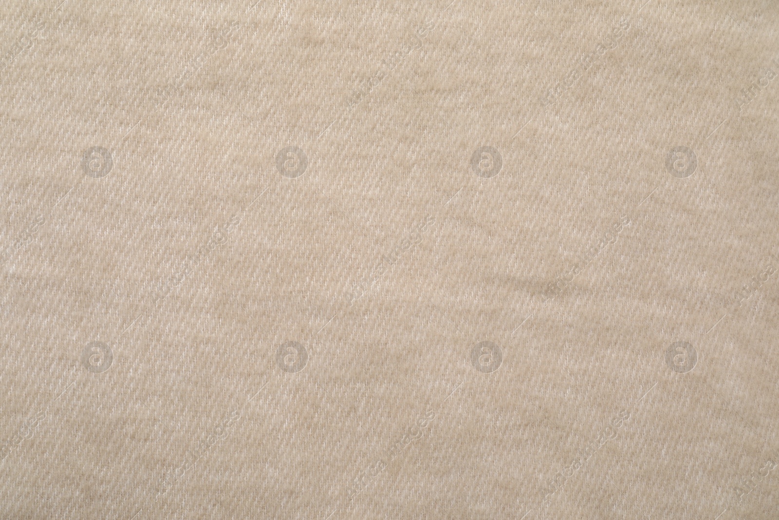 Photo of Texture of beige blanket as background, top view