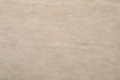 Photo of Texture of beige blanket as background, top view