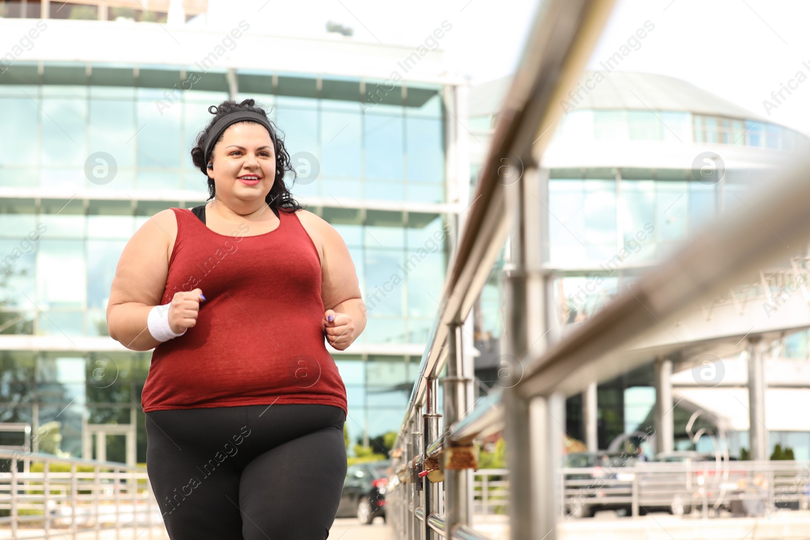 Photo of Beautiful overweight woman running outdoors. Fitness lifestyle