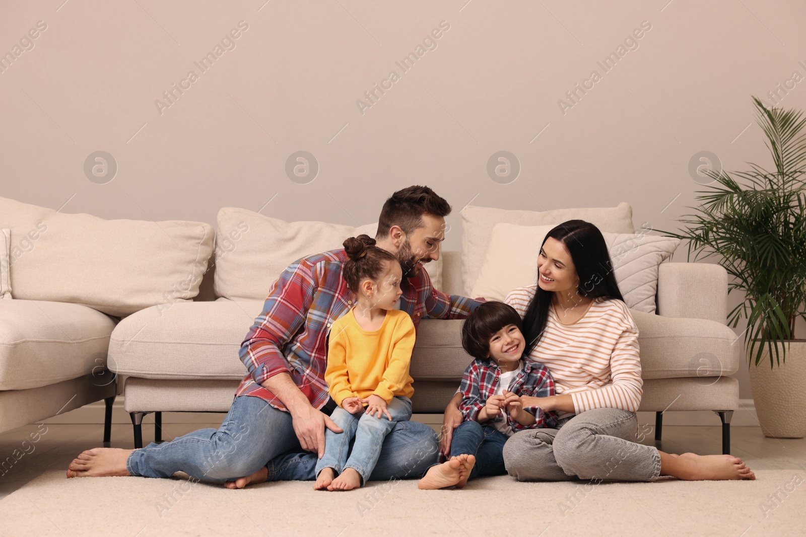 Photo of Happy family spending time together in living room