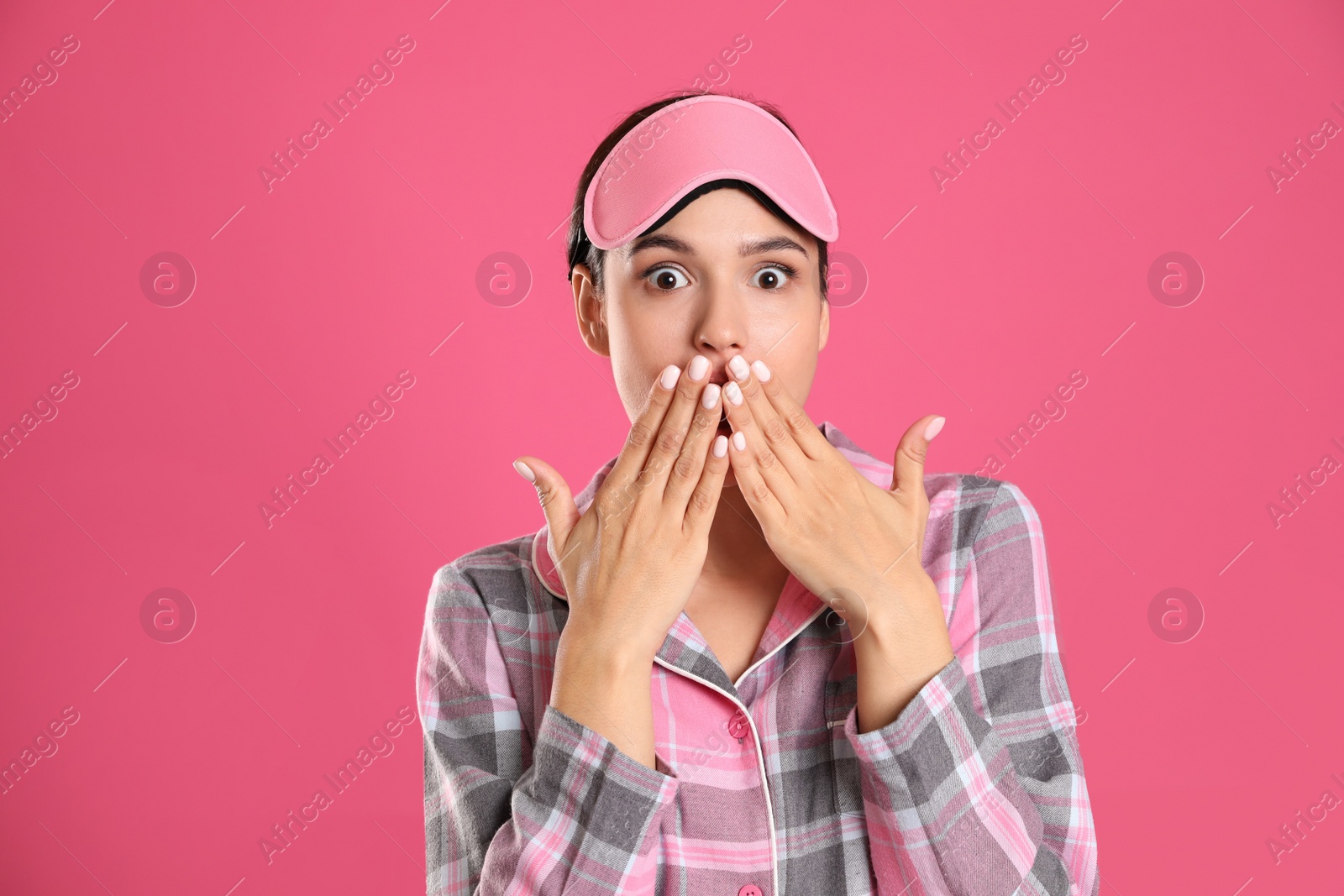 Photo of Beautiful woman wearing sleeping mask on pink background. Bedtime