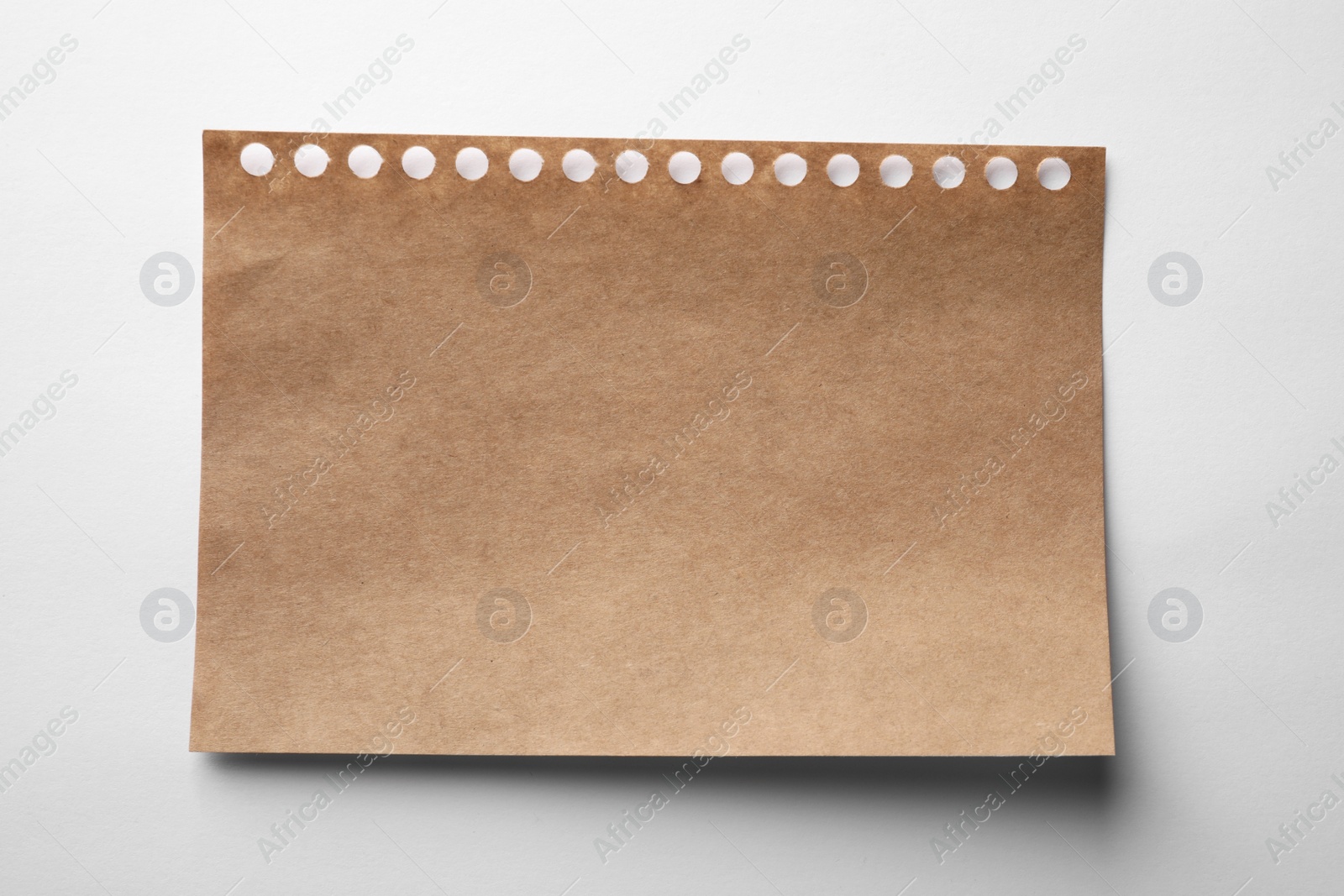 Photo of Brown sheet of paper on white background, top view