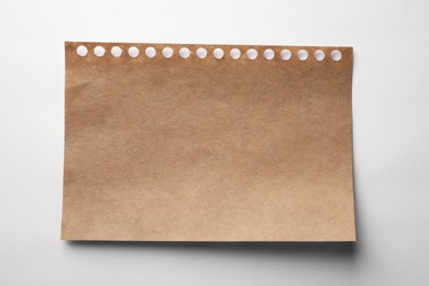 Brown sheet of paper on white background, top view