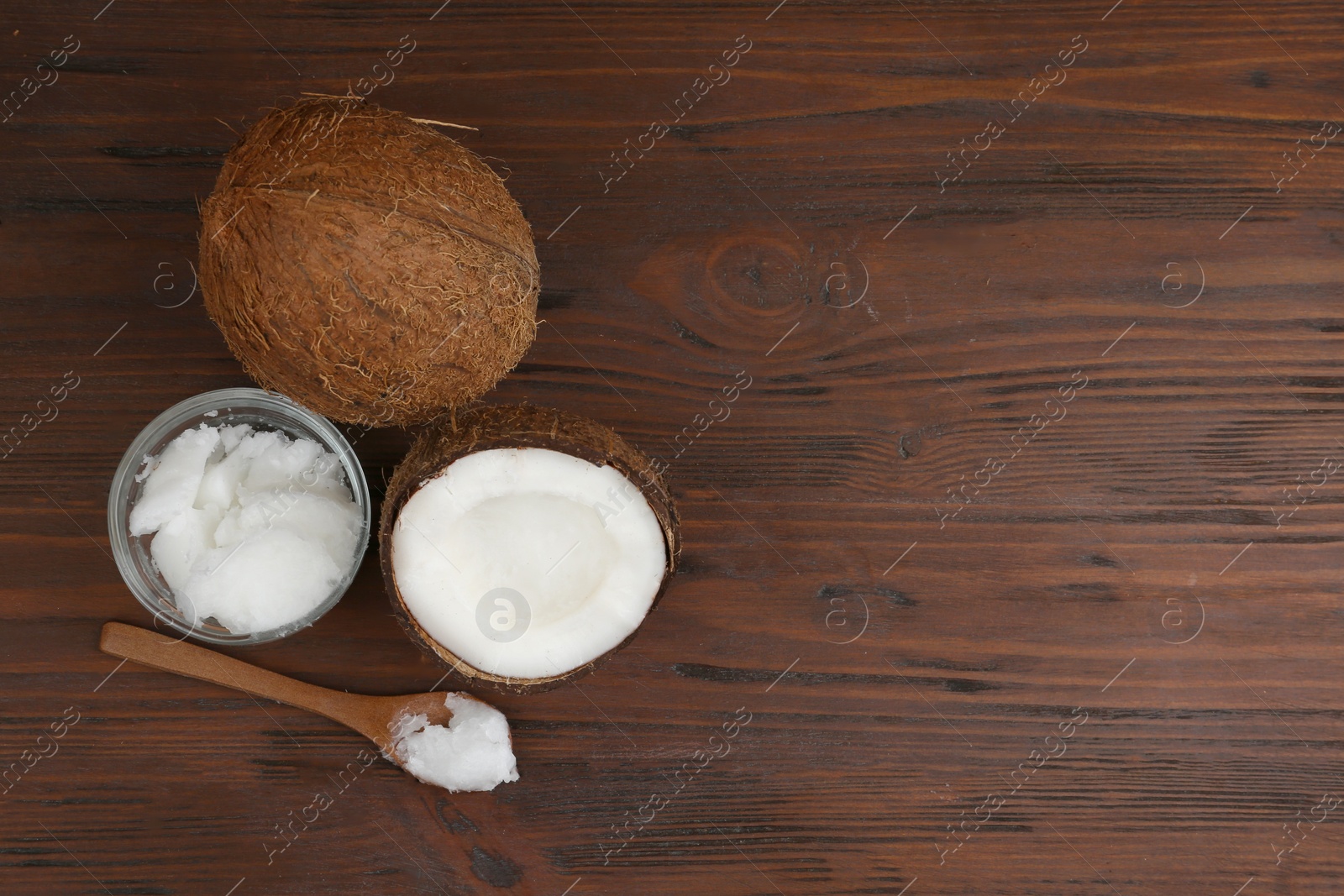 Photo of Flat lay composition with organic coconut oil on wooden table, space for text. Healthy cooking