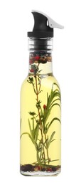 Photo of Glass bottle of cooking oil with spices and herbs isolated on white