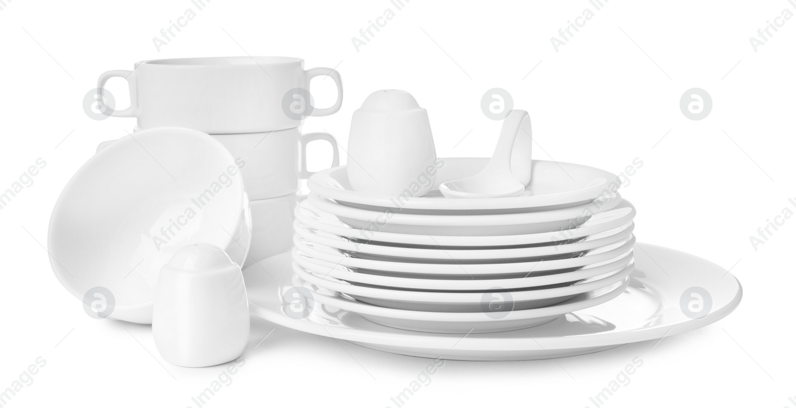 Photo of Set of clean dishware isolated on white