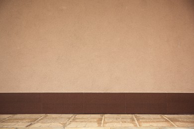 Photo of Beautiful plaster beige wall and concrete pavement