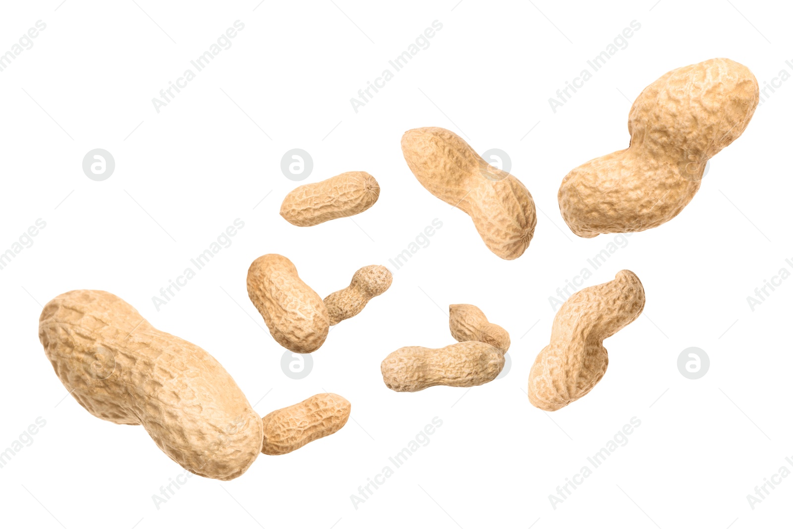 Image of Unpeeled peanuts in air on white background