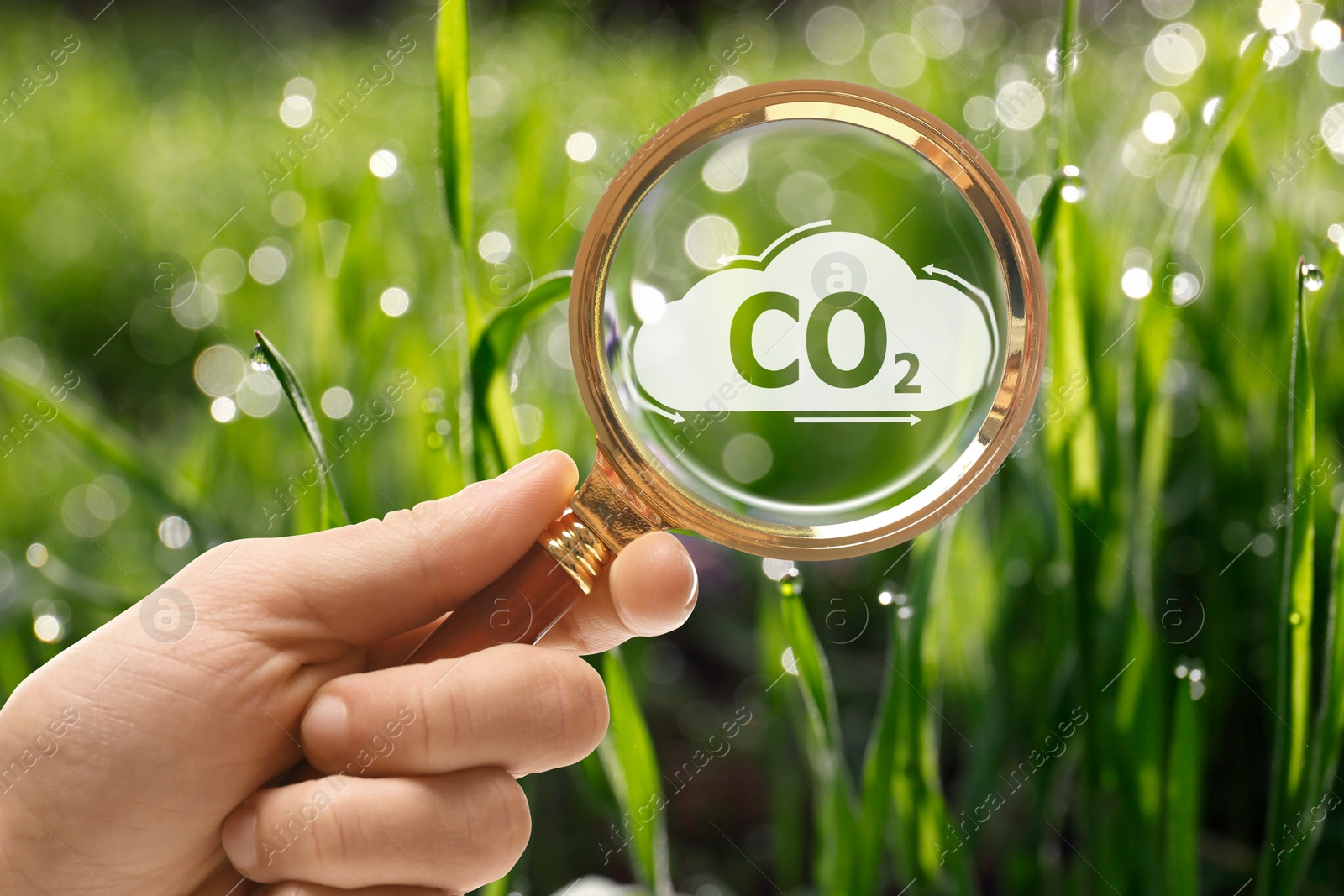 Image of Concept of clear air. Woman demonstrating CO2 inscription through magnifying glass outdoors, closeup