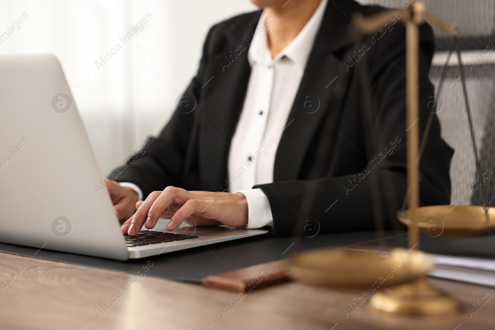 Photo of Notary using laptop at workplace in office, closeup
