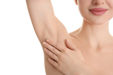 Young beautiful woman showing armpit with smooth clean skin on white background, closeup