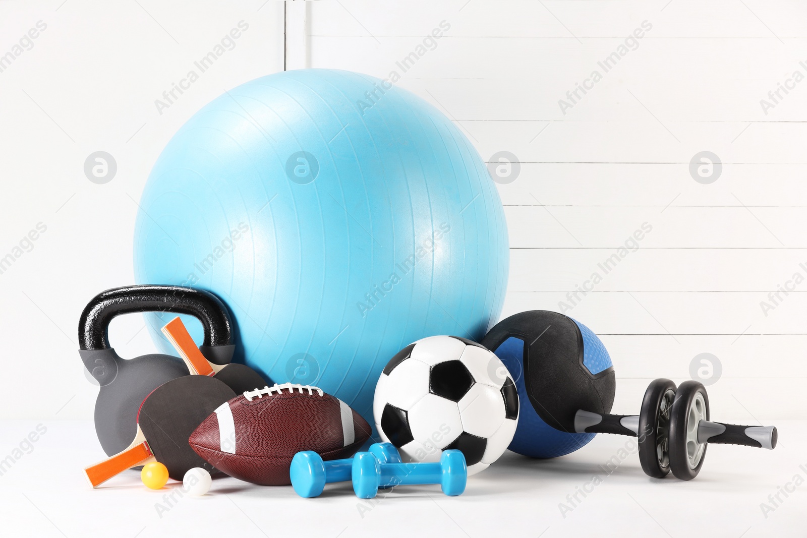 Photo of Many different sports equipment on white table