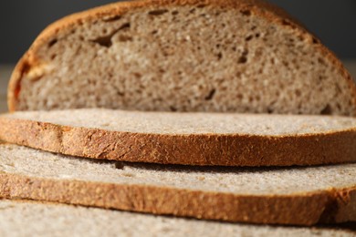 Photo of Freshly baked cut sourdough bread on table, closeup