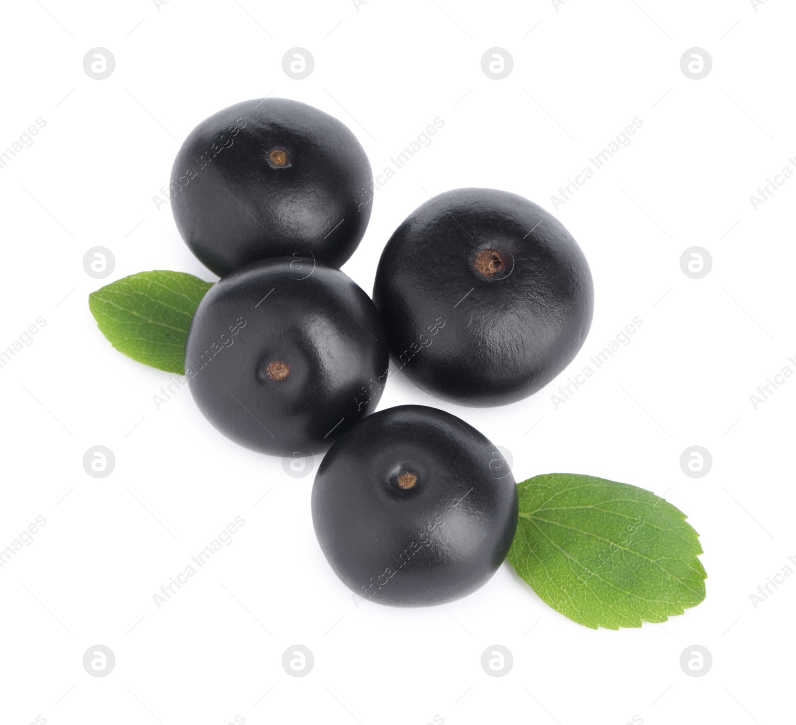 Photo of Pile of fresh ripe acai berries and green leaves on white background, top view