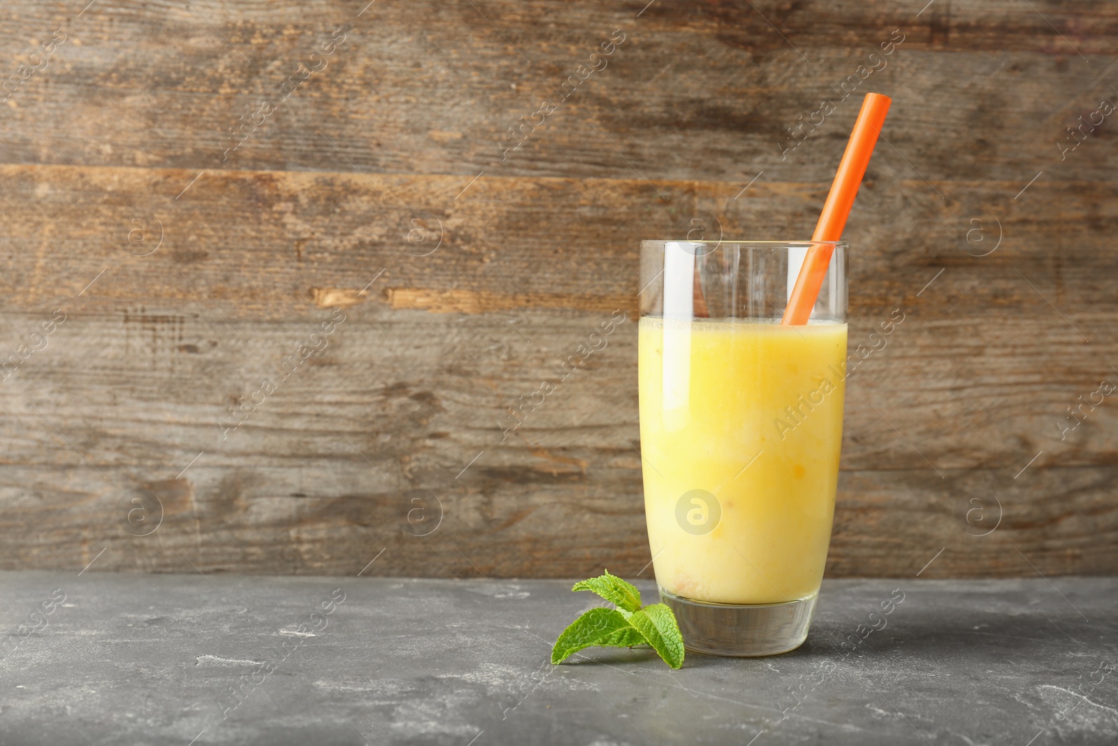 Photo of Glass with delicious detox smoothie on table