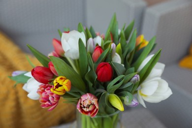 Beautiful bouquet of colorful tulips on blurred background, closeup view