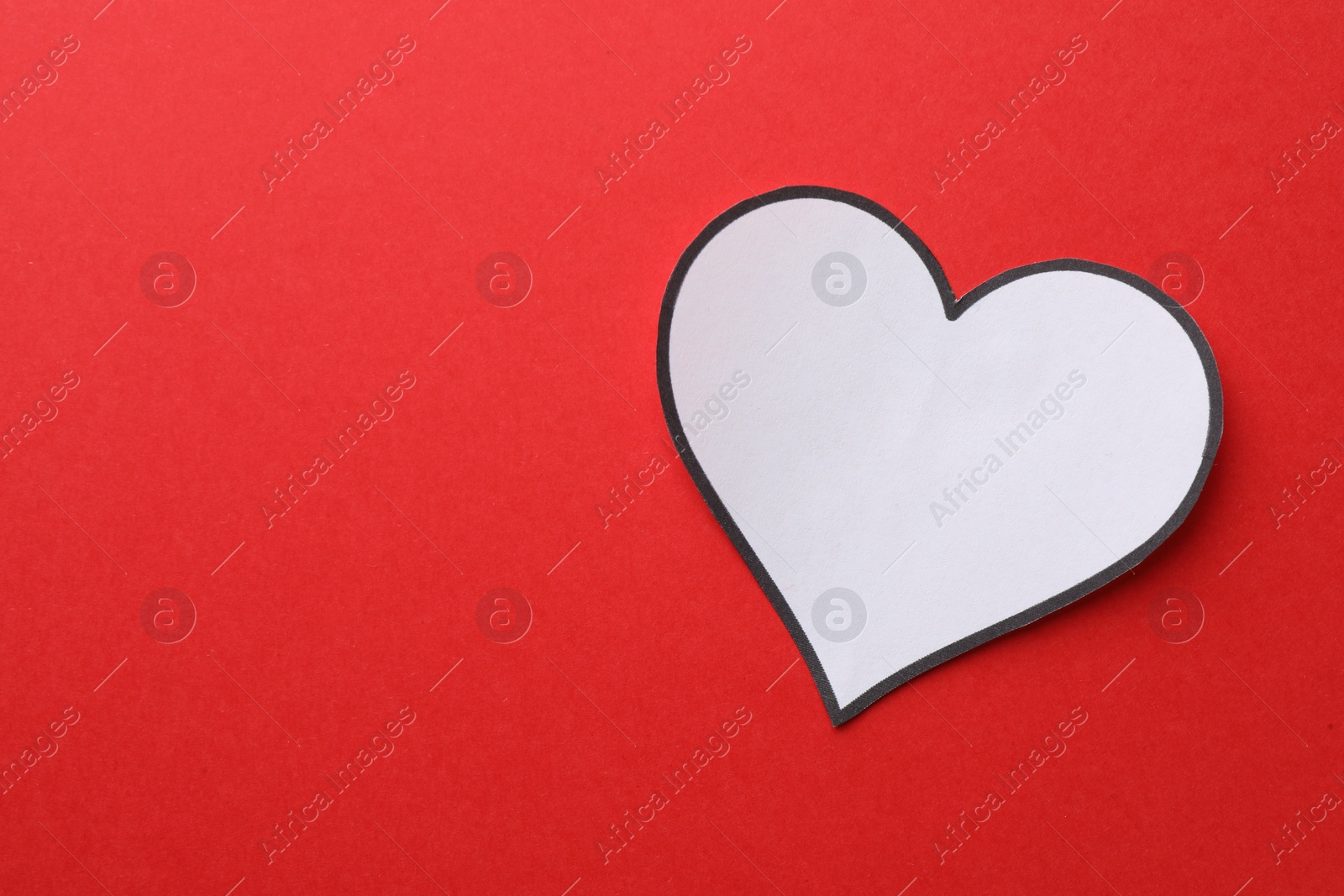 Photo of White paper heart on red background, top view. Space for text