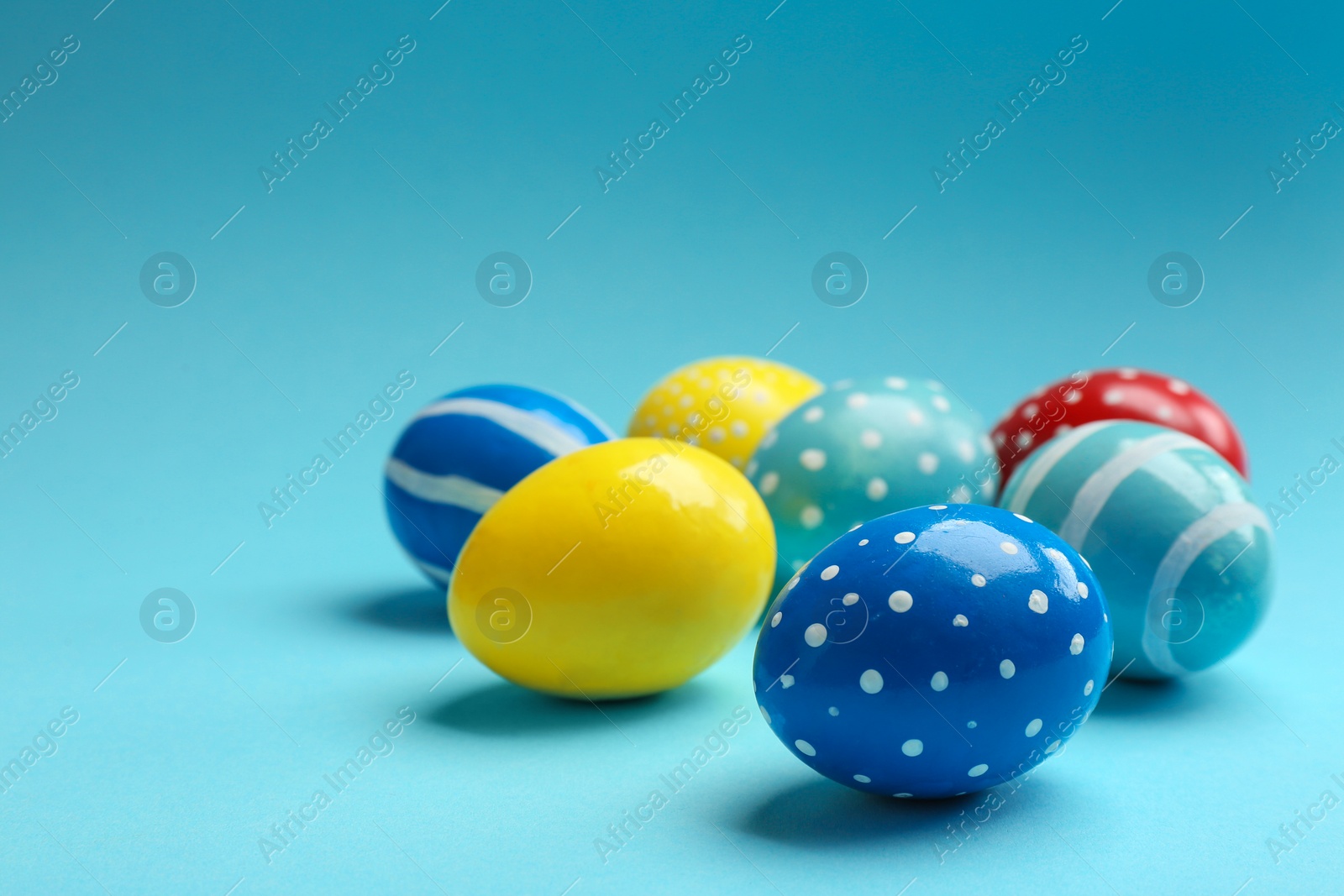 Photo of Painted Easter eggs on color background, space for text