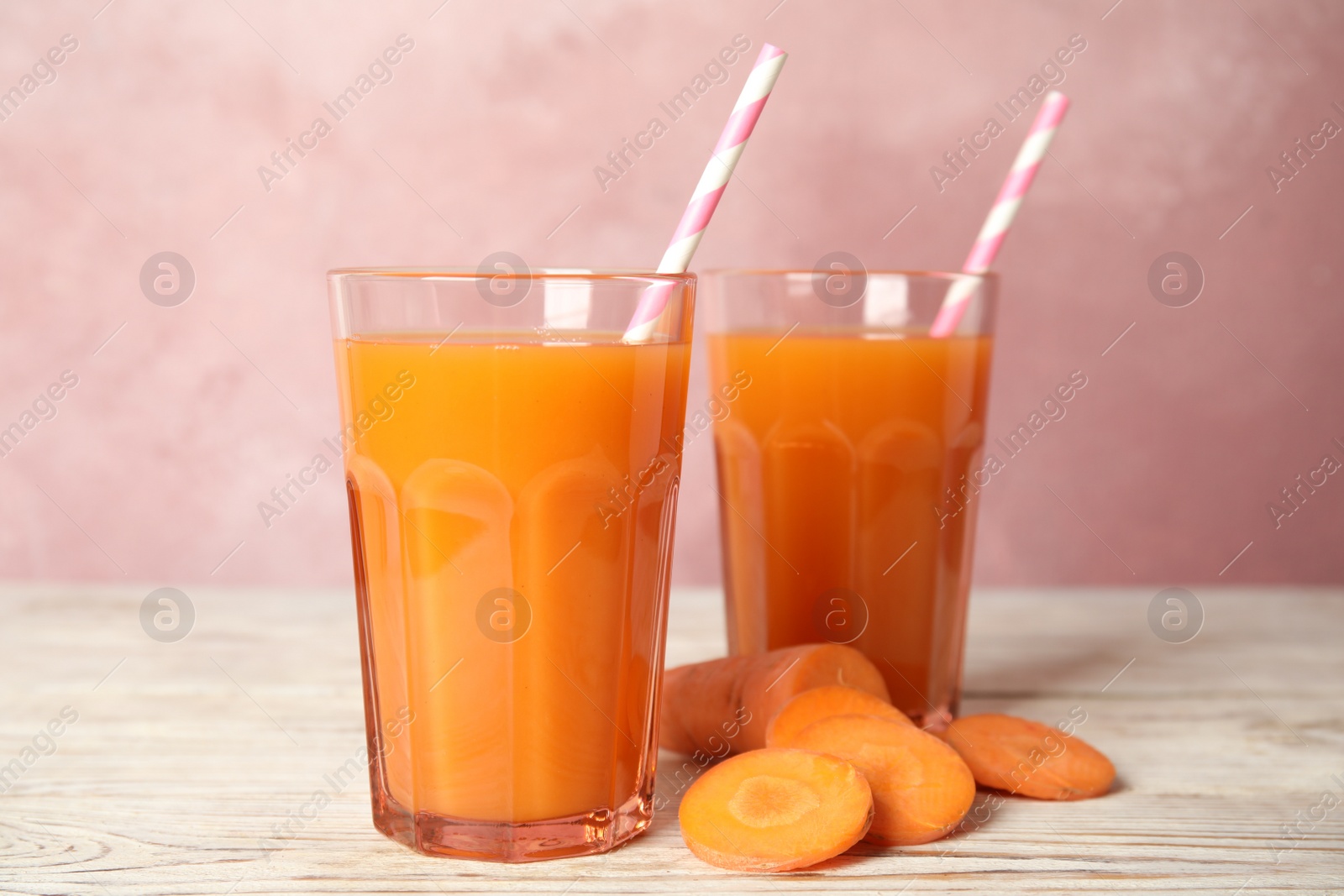 Photo of Freshly made carrot juice on wooden table