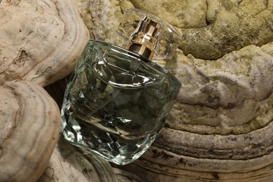 Photo of Luxury perfume in bottle on textured surface