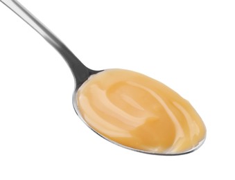 Photo of Spoon with tasty salted caramel isolated on white
