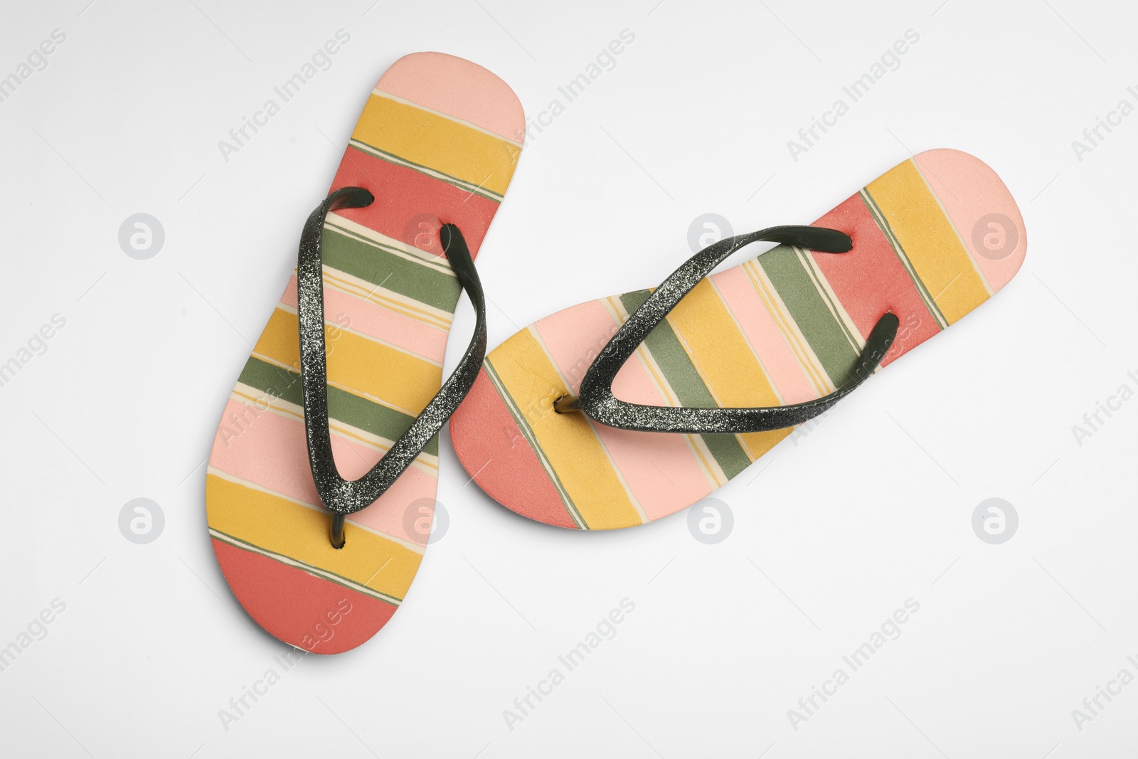 Photo of Pair of flip flops on white background, top view. Beach accessories