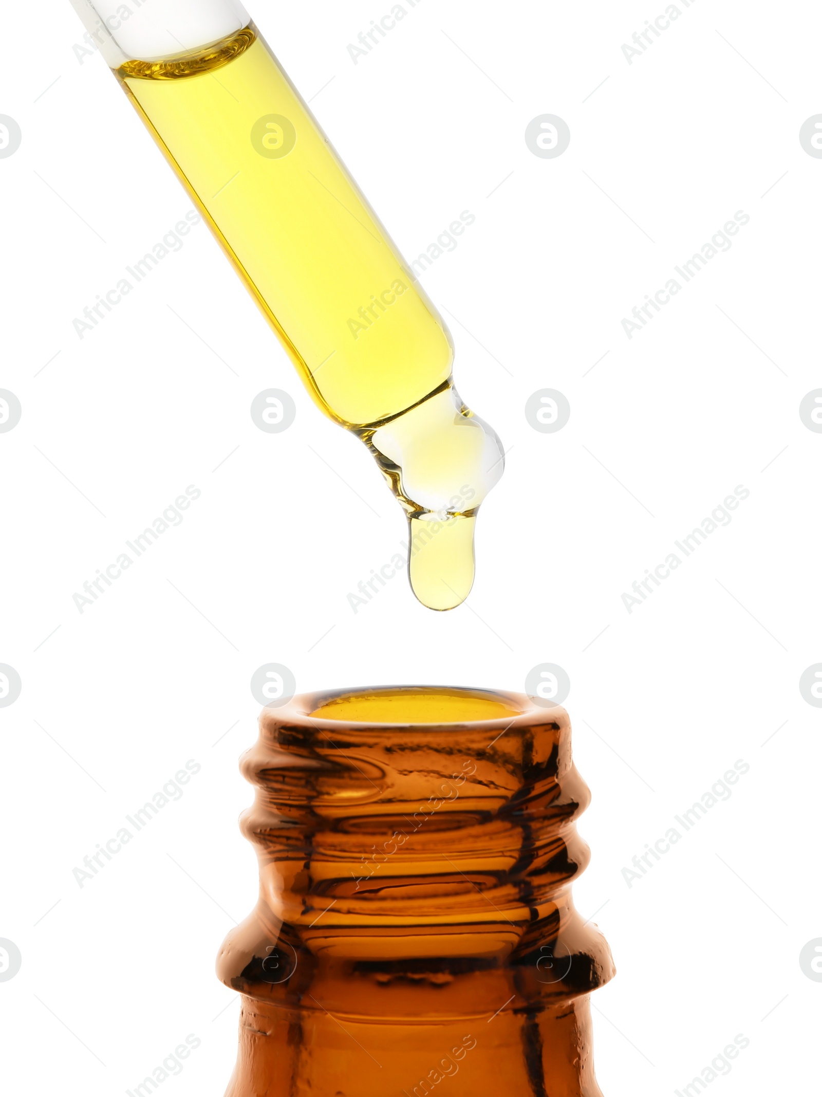 Photo of Dripping tincture from pipette into bottle isolated on white